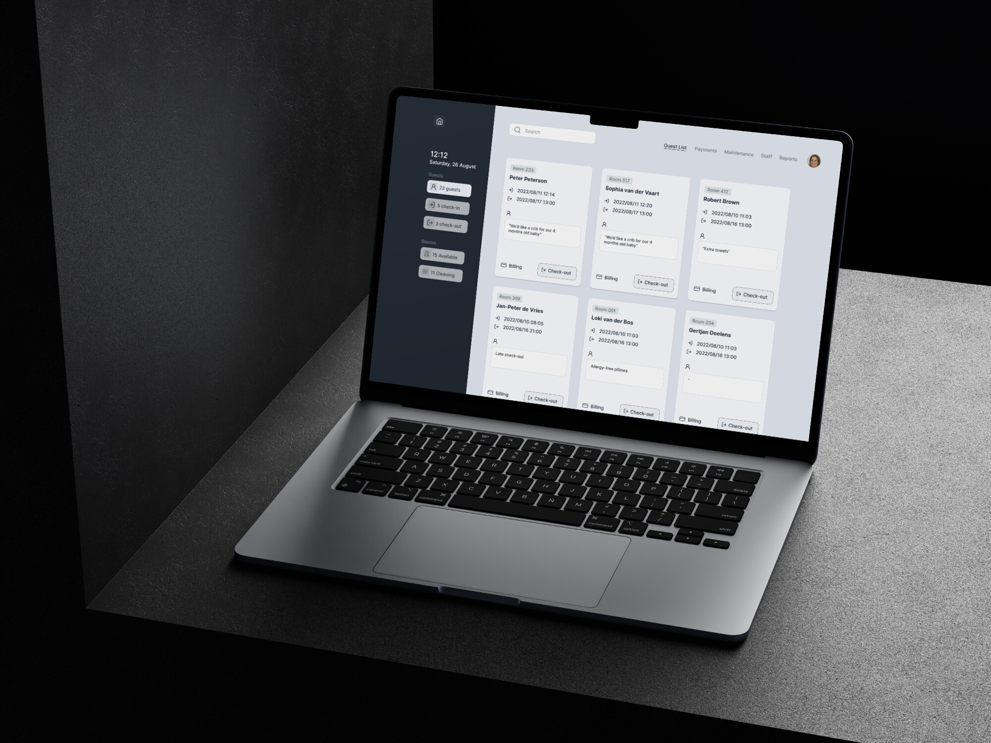 A laptop displays a hotel room booking interface, showing a list of guest names and check-in/check-out times. The interface features a clean, card-based layout with a search bar and a minimal design, typical of a modern booking system.